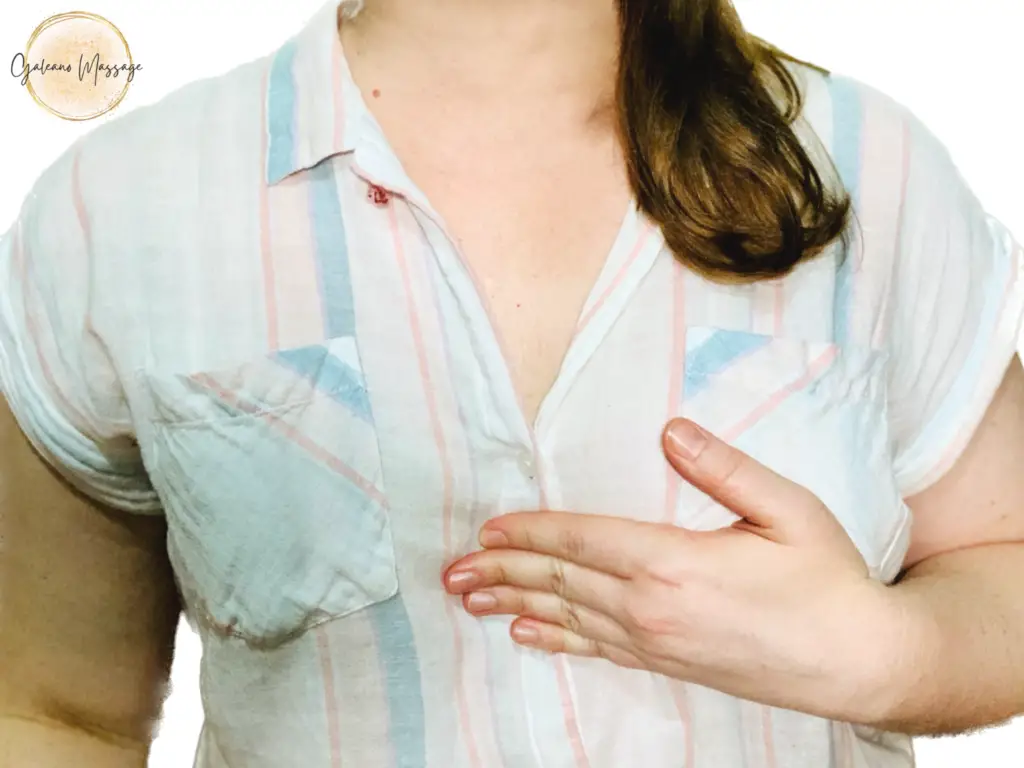 Sarah Galeano is holding four fingers of her left hand flat against her sternum. White background with gold circles and dots logo with Galeano Massage in black cursive letters in the upper left corner.
